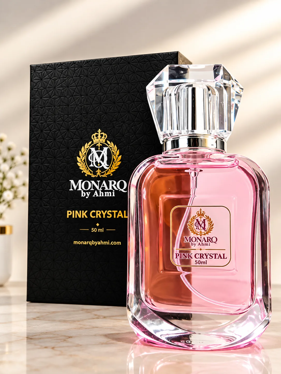 Monarq Pink Crystal 50ml pink perfume bottle beside its black gift box